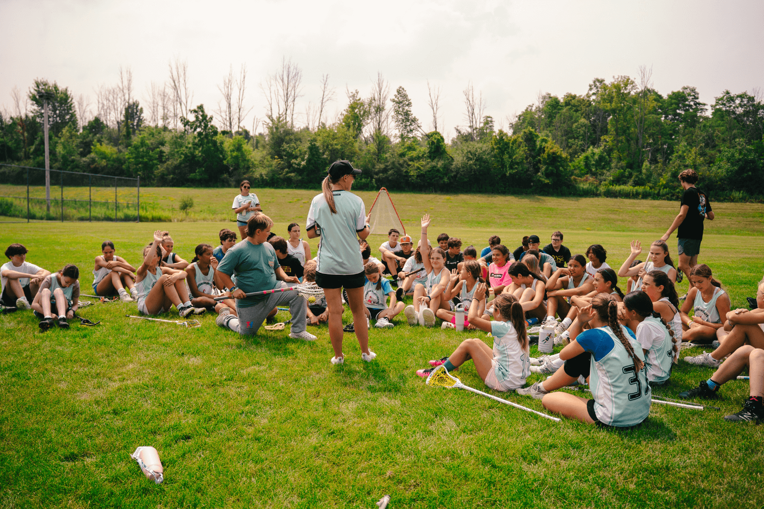 Group of campers listening to counselor at overnight sports camp