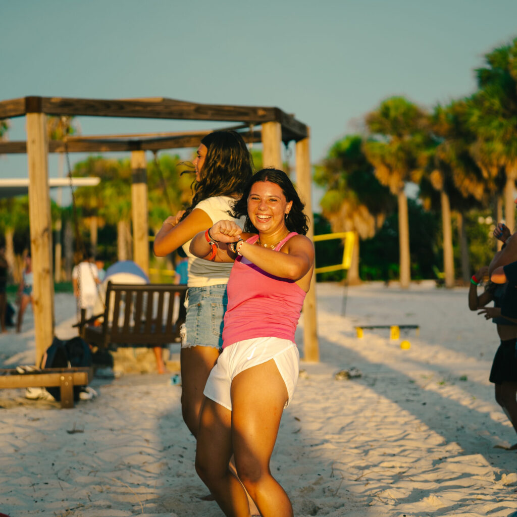 girl lacrosse player participates in beach activities at overnight lacrosse camp in florida