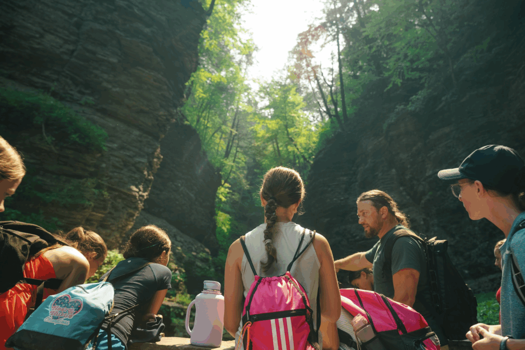 Campers exploring Watkins Glen State Park with a tour guide during outdoor adventures at Signature Sports Camps