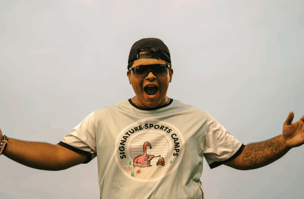 Excited summer camp coach at Signature Sports Camps cheering on campers