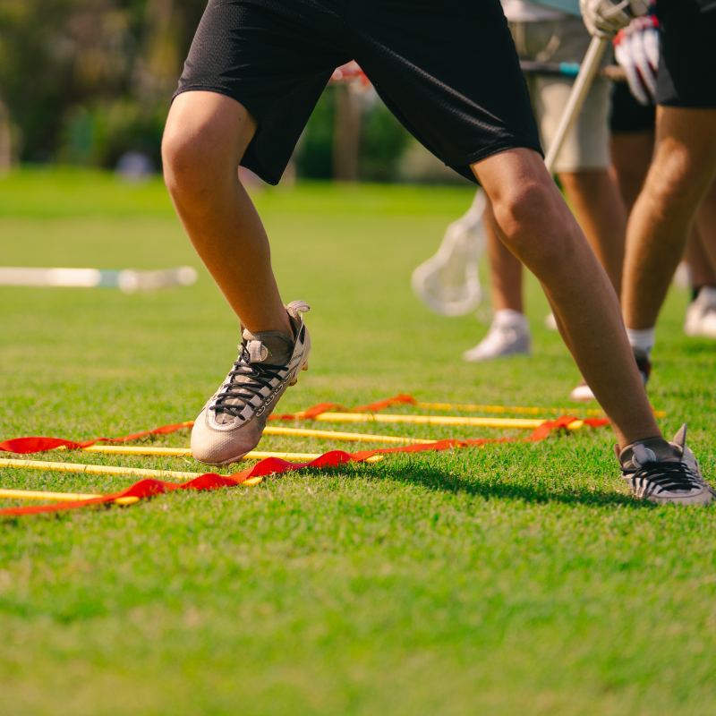Athlete doing a ladder drill during sports camp training