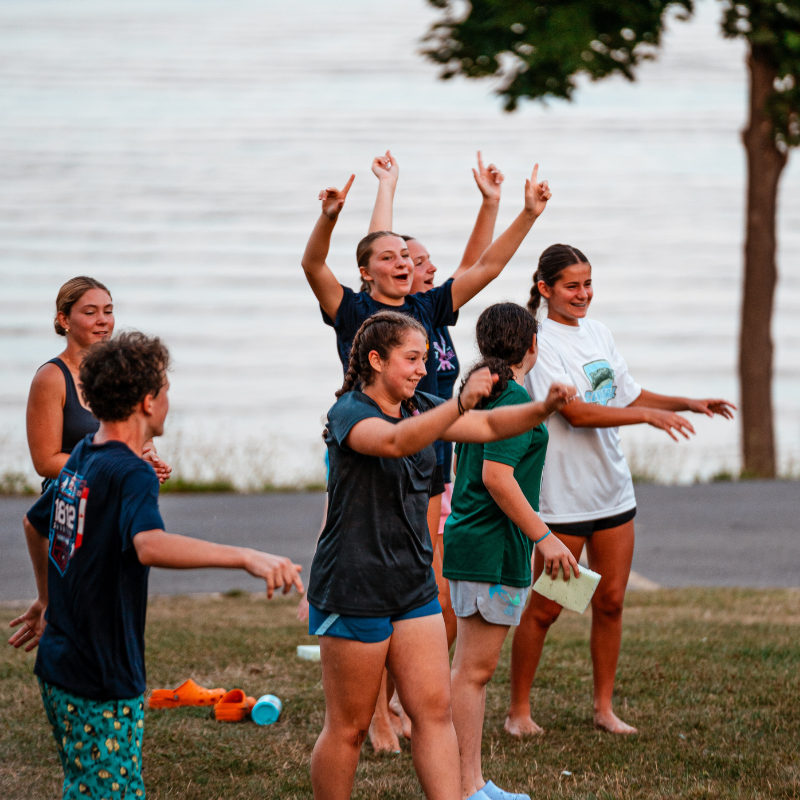 Group of kids cheering during a game at sports camp