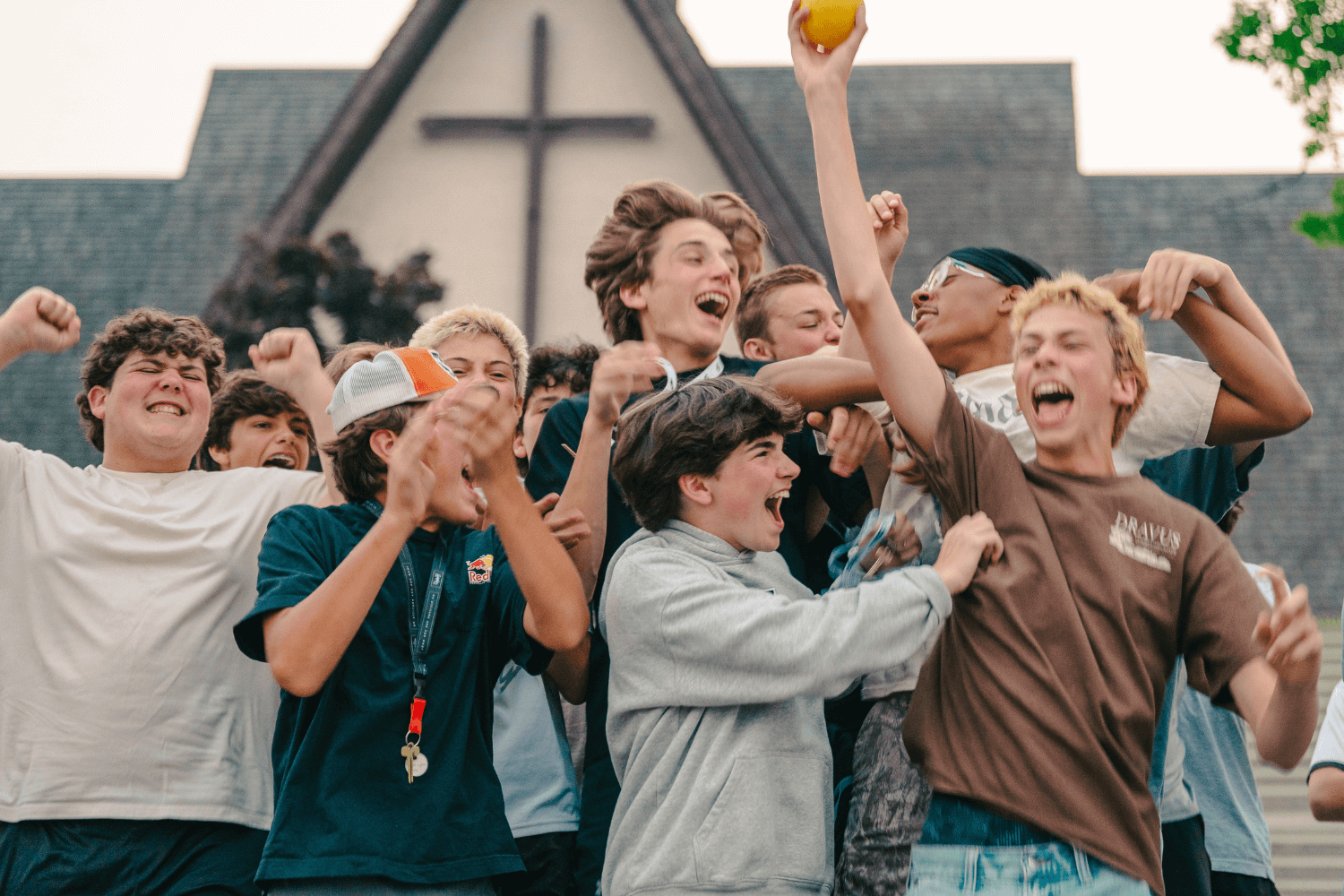 Boys at overnight sports camp cheer together in celebration
