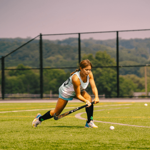 girl practicing field hockey at summer sports camps