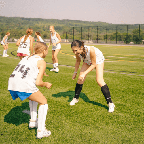 field hockey players practicing position specific drills at camp