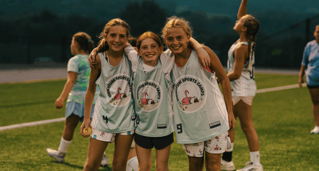 Smiling female athletes after training at Signature Sports Camps summer sports camp.