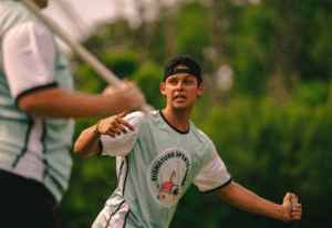 Boys lacrosse coach providing one-on-one training at Signature Sports Camps.