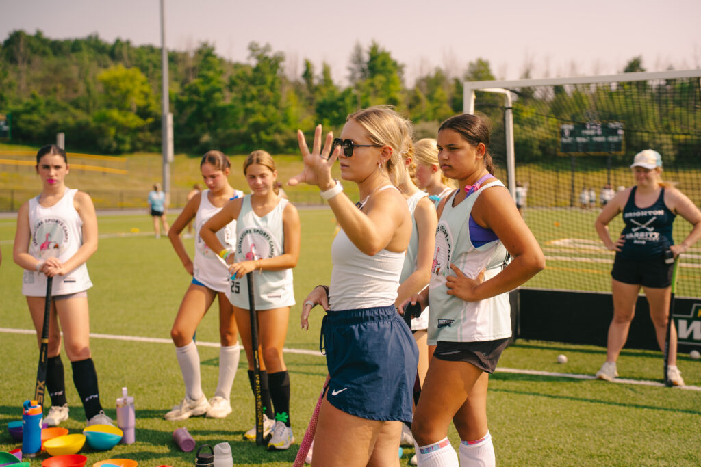 Great youth sports coach leading a small group drill at Signature Sports Camps