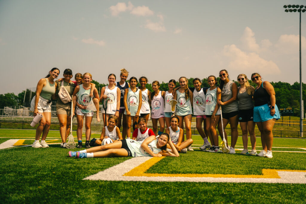 Group of female coaches with players, smiling