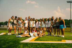 Group of female coaches with players, smiling