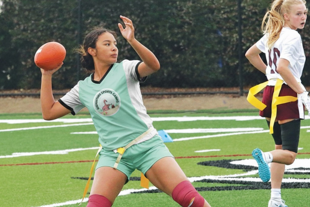 Girl playing Flag Football at camp.