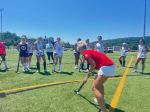 Danielle Grega showing a drill to campers.