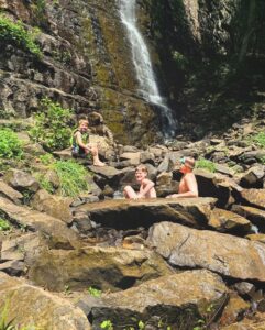 Boys climbing the waterfall at Foster Falls.